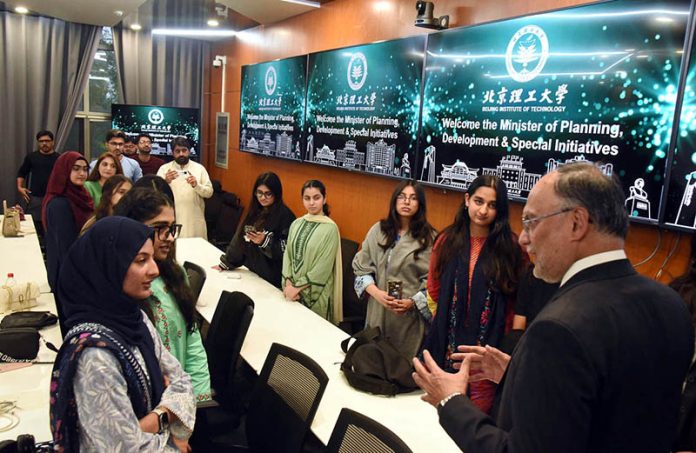 Federal Minister for Planning, Development and Special Initiatives, Professor Ahsan Iqbal, interacting with Pakistani students at Beijing Institute of Technology
