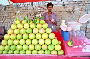 A vendor papering grapefruit juice for customers at Railway Station Road.
