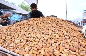A vendor arranges dates on his cart to attract customers for sell at Miro Khan Road.