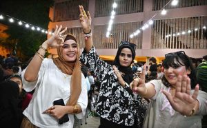 People enjoy watching the Asia Cup T20 final cricket match between India and Pakistan on a big screen at the Arts Council