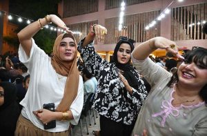 People enjoy watching the Asia Cup T20 final cricket match between India and Pakistan on a big screen at the Arts Council