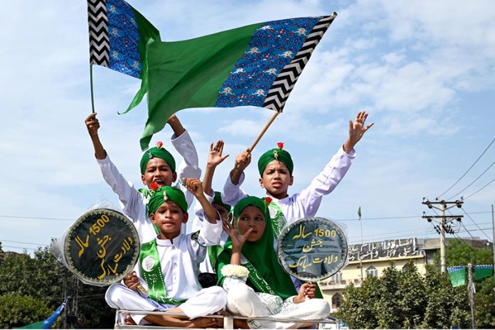 Children carrying flags during participate in a religious procession to celebrate Eid-e-Milad-un-Nabi(S.A.AW), commemoration of the birth anniversary of Prophet Muhammad(PBUH)