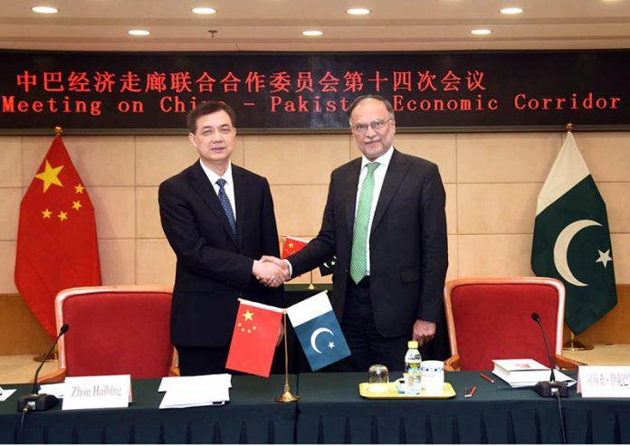 Federal Minister for Planning, Development and Special Initiatives, Professor Ahsan Iqbal, shaking hands with Zhou Haibing, Vice Chairman, after the 14th meeting of the Joint Cooperation Committee (JCC) of CPEC