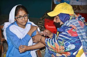 A lady health worker is administering cervical cancer vaccine to student at Government Muslim Girls High School, Eidgah Road.