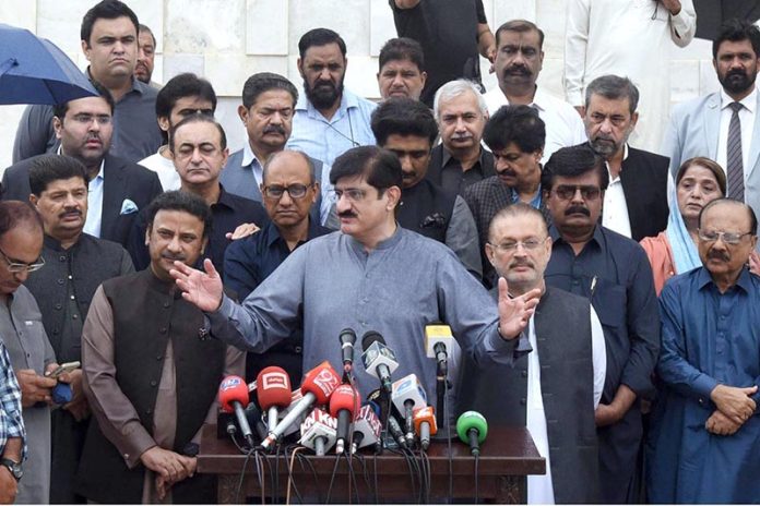 Sindh Chief Minister Syed Murad Ali Shah, flanked by cabinet members, addresses the media at Mazar-e-Quaid