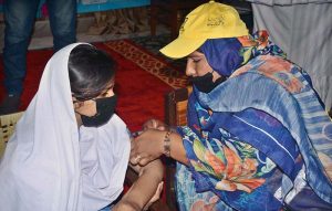 A lady health worker is administering cervical cancer vaccine to student at Government Muslim Girls High School, Eidgah Road.