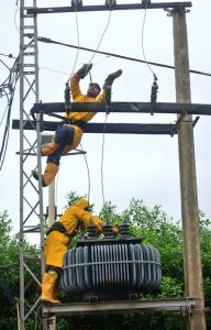 HESCO workers repair wires and transformer on an electric pole at Hilltop Road to prevent power fluctuations and outages.