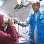 An Afghan refugee girl being de-registered by UNHCR staff at the Voluntary Repatriation Center before returning to Afghanistan