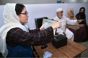 An Afghan refugee girl being de-registered by UNHCR staff at the Voluntary Repatriation Center before returning to Afghanistan