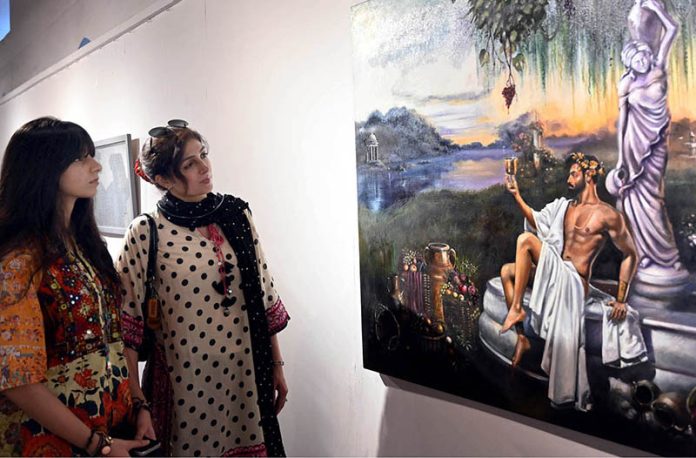 Visitors admire outstanding artworks on display during the Degree Show at the NCA Gallery