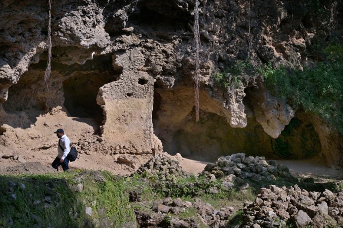 The Buddha Caves at Shah Allah Ditta are located in the heart of Margalla Hills on the natural route to the ancient city of Taxila. These caves are believed to be 2,400 years old. The Buddha caves are adjacent to a garden known as Sadhu ka Bagh. The village of Shah Allah Ditta is named on a dervish of Mughal era. The Buddha Caves consist of natural rock of Kanjur stone. The Kanjur stone used for the construction of Buddhist Stupa at Ban Faqiran, was also extracted from these rocks. These caves were first used by Buddhist monks for meditation. After the decline of Buddhism in Taxila. Hindu sadhus occupied these caves and painted some images of Hindu deities on the walls. There were many Hindu families living in Shah Allah Ditta Village before partition and the Caves were used by them for their daily worship. During the Mughal Period, Muslim ascetics took over the caves and built a square water tank on the water channel emerging from a natural water spring flowing since long. The water tank was constructed in lime stone laid in lime mortar. Mughal rulers and other emperors often passed through this region on their way to India from Afghanistan