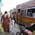 Citizens board a bus to leave the city as precautionary measures amid rising flood threats