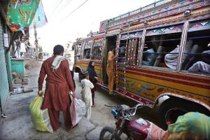 Citizens board a bus to leave the city as precautionary measures amid rising flood threats