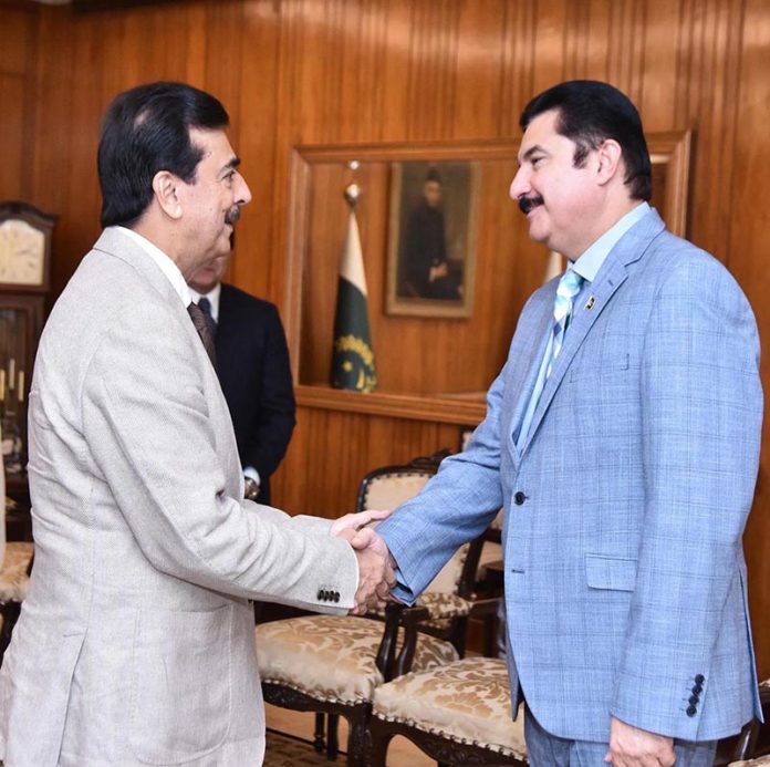 Acting President Syed Yousuf Raza Gilani shaking hands with Governor of Khyber Pakhtunkhwa, Mr. Faisal Karim Kundi, at Aiwan-e-Sadr.
