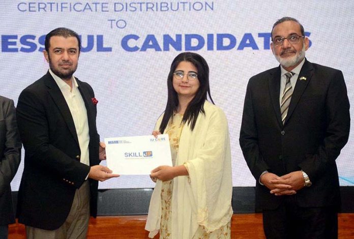 Advisor to Federal Finance Minister, Khurram Schehzad distributing certificates to graduates of the “Skill-Up Batch-II” program at Iqra University