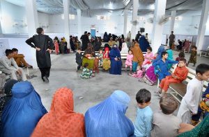 Afghan refugee families wait for their turn to be de-registered at the UNHCR repatriation center before departing for Afghanistan