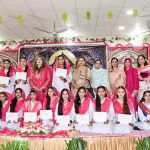 Students pose for a group photo with Professor Dr. Fareeha Hikmat during the Milad ceremony at Associate College for Women, Dhoke Elahi Bakhsh
