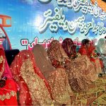 Brides sitting on stage during a mass wedding ceremony organized by Jillani Welfare Foundation at Bagh-e-Mustafa Ground