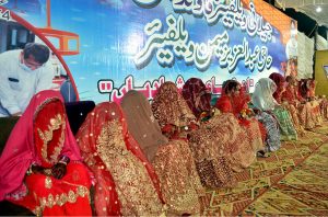 Brides sitting on stage during a mass wedding ceremony organized by Jillani Welfare Foundation at Bagh-e-Mustafa Ground