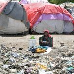 A gypsy woman washing clothes outside her hut at Makki Shah area