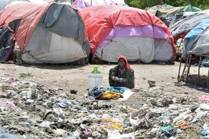A gypsy woman washing clothes outside her hut at Makki Shah area