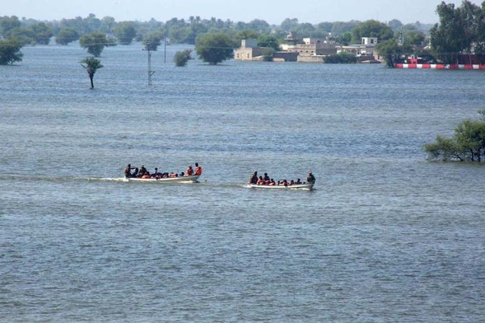 Rescue 1122 Boats carrying residents evacuates people from flooded areas after rising river water submerged villages