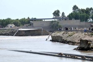 A view of the breach point at Gilani embankment as high flow of flood water posing a threat to nearby settlements