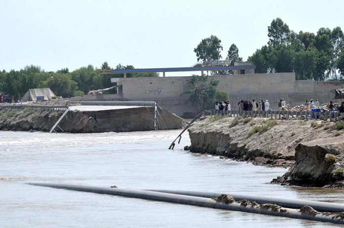 A view of the breach point at Gilani embankment as high flow of flood water posing a threat to nearby settlements