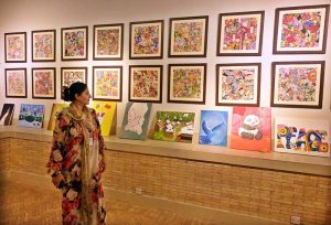 A visitor keenly observes an artwork during a joint exhibition titled “A Restrained Grace” featuring drawings by Ustad Bashir ud Din, and “Bleeding Borders” showcasing installations by Amin Rehman, curated by Aasim Akhtar, at PNCA.