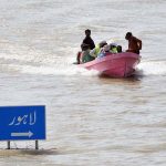 A rescue boat evacuates residents stranded in submerged villages unerground the flood water after rising river water engulfed surrounding areas