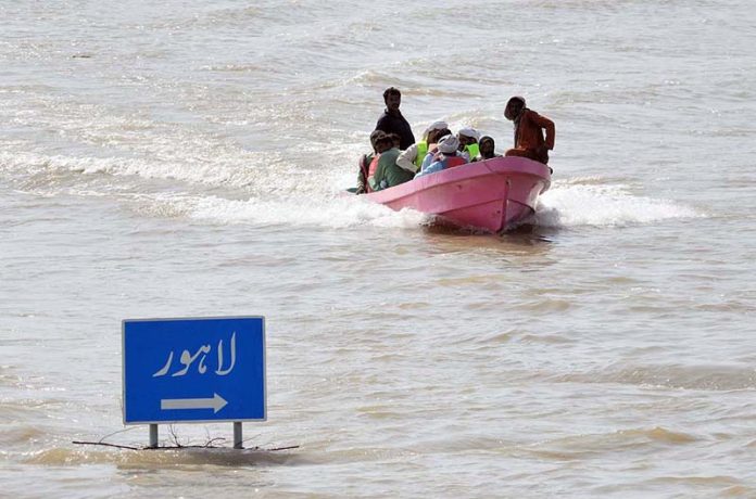 A rescue boat evacuates residents stranded in submerged villages unerground the flood water after rising river water engulfed surrounding areas