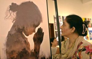 A visitor keenly observes an artwork during a joint exhibition titled “A Restrained Grace” featuring drawings by Ustad Bashir ud Din, and “Bleeding Borders” showcasing installations by Amin Rehman, curated by Aasim Akhtar, at PNCA.