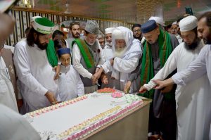 People cutting cake on the eve of Eid Milad-un-Nabi (SAWW) commemoration of the birth anniversary of Prophet Mohammed (SAAW)