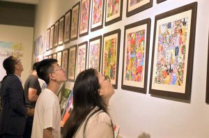 A visitor keenly observes an artwork during a joint exhibition titled “A Restrained Grace” featuring drawings by Ustad Bashir ud Din, and “Bleeding Borders” showcasing installations by Amin Rehman, curated by Aasim Akhtar, at PNCA.