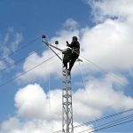 A WAPDA staffer is busy installing new electricity lines in Sachal Colony