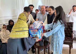 Japanese student Ms. Hikari Kiran Shah Tokunaga donating sewing machines to flood-affected families.