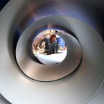 An ironsmith cuts a stainless steel sheet outside his workplace in the provincial capital