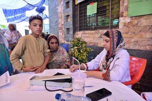 Doctors examine and treat patients at a free medical camp in Village Khoje Chak, organized by the Shed Trust to provide healthcare facilities to flood-affected residents.