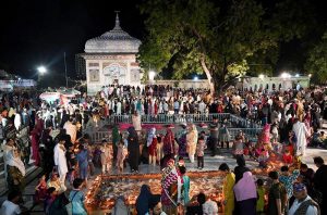 Devotees lighting candles and earthen lamps at the shrine of Sufi saint Hazrat Mian Mir during the 402nd Urs celebration.
