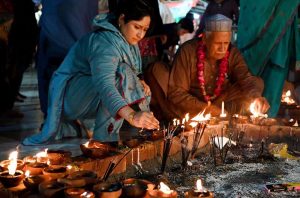 Devotees lighting candles and earthen lamps at the shrine of Sufi saint Hazrat Mian Mir during the 402nd Urs celebration.