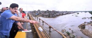 Sindh Chief Minister Syed Murad Ali Shah, accompanied by provincial ministers, inspects the Lyari River flowing at peak levels near the Machhar Colony section of the Lyari Expressway