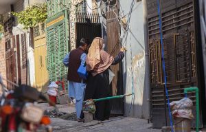 A polio worker marks the house of a child after administering polio drops during the anti-polio vaccination campaign at Tarlai area in the Federal Capital