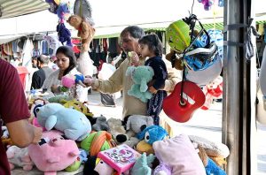 Women busy in selecting and purchasing old warm clothes at weekly bazaar in the Federal Capital