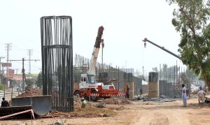 Labourers are busy construction work of T-Chowk Flyover during development work in Federal Capital.