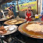 Workers are busy frying fish for customers at 6th Road as demand increases during winter season