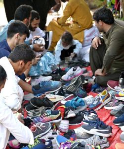 Women are busy selecting and purchasing second hand warm clothes from vendor at weekly bazaar, I-9/4 in the Federal Capital.