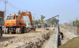 Labourers are busy construction work of T-Chowk Flyover during development work in Federal Capital.