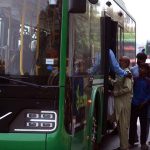 Commuters board an electric bus along Samundari Road, embracing modern and eco-friendly transport as a step toward combating climate change