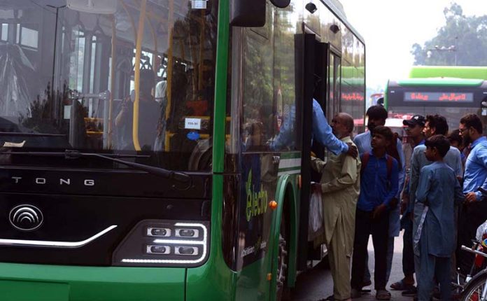 Commuters board an electric bus along Samundari Road, embracing modern and eco-friendly transport as a step toward combating climate change
