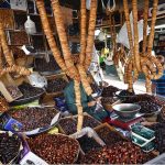 A vendor displaying different types of dates and dry fruit to attract the customers at weekly bazaar in the Federal Capital